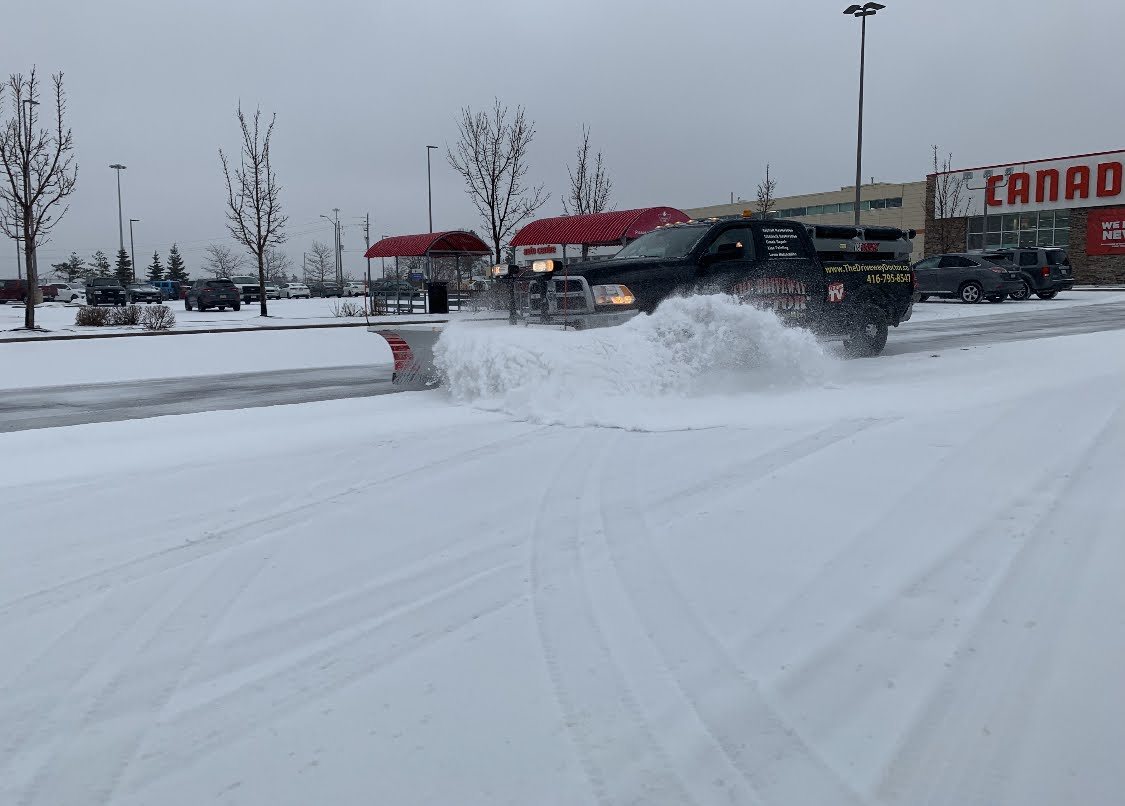 Commercial snow plowing in a parking lot